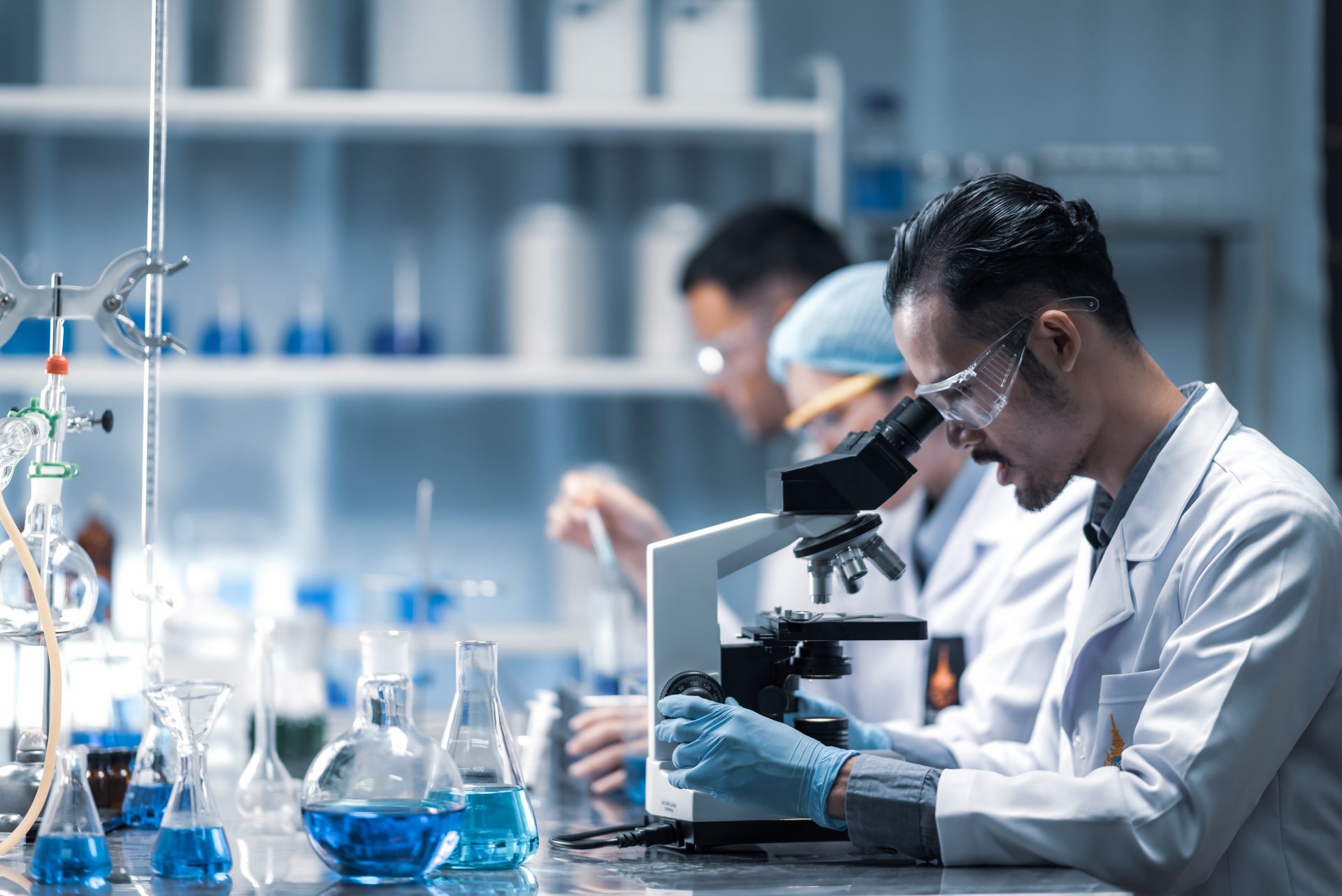 young-scientist-looking-through-microscope-laboratory-young-scientist-doing-some-research